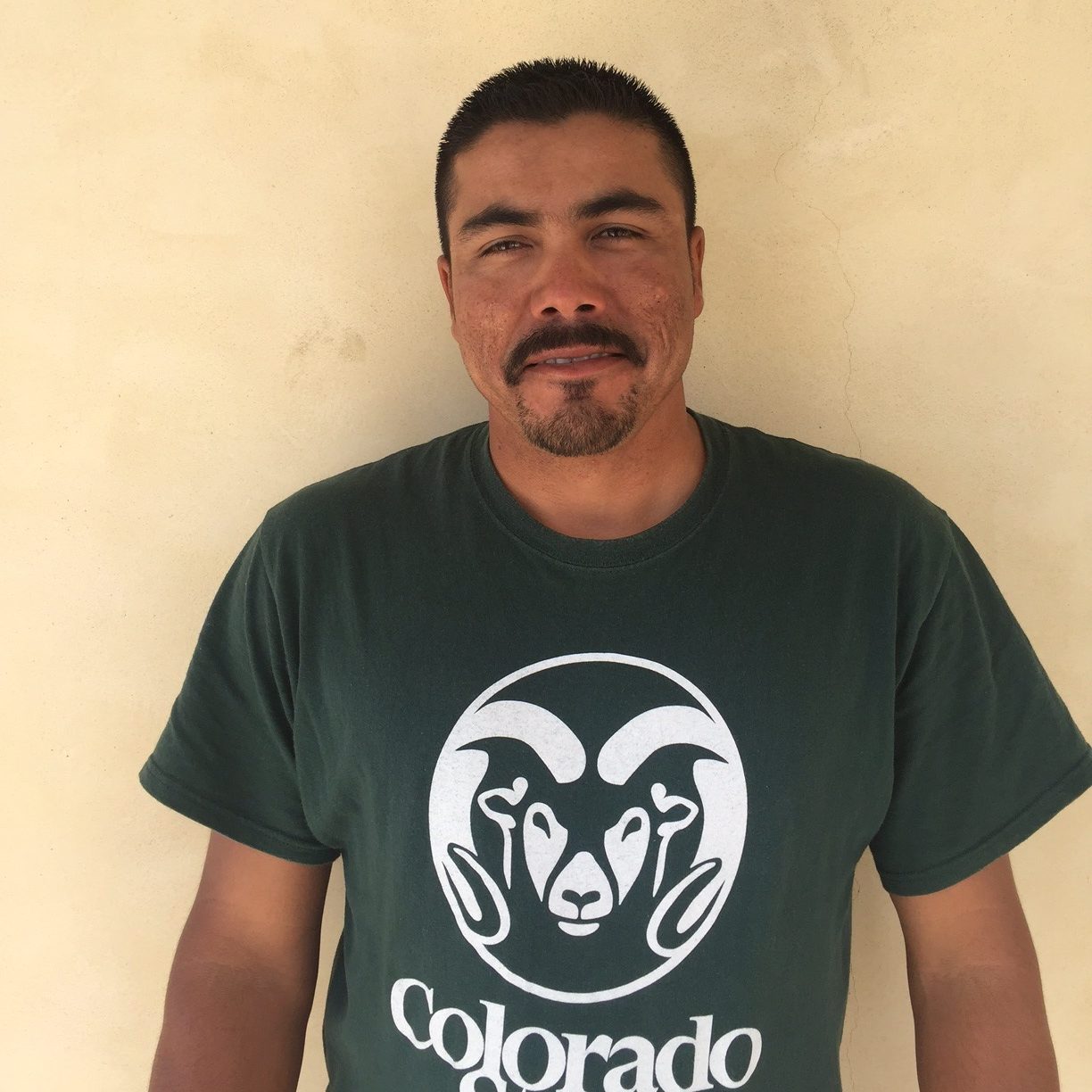 Man with a mustache and goatee wearing a CSU Rams t-shirt.